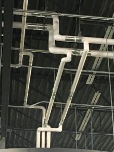 Plumbing pipes across ceiling